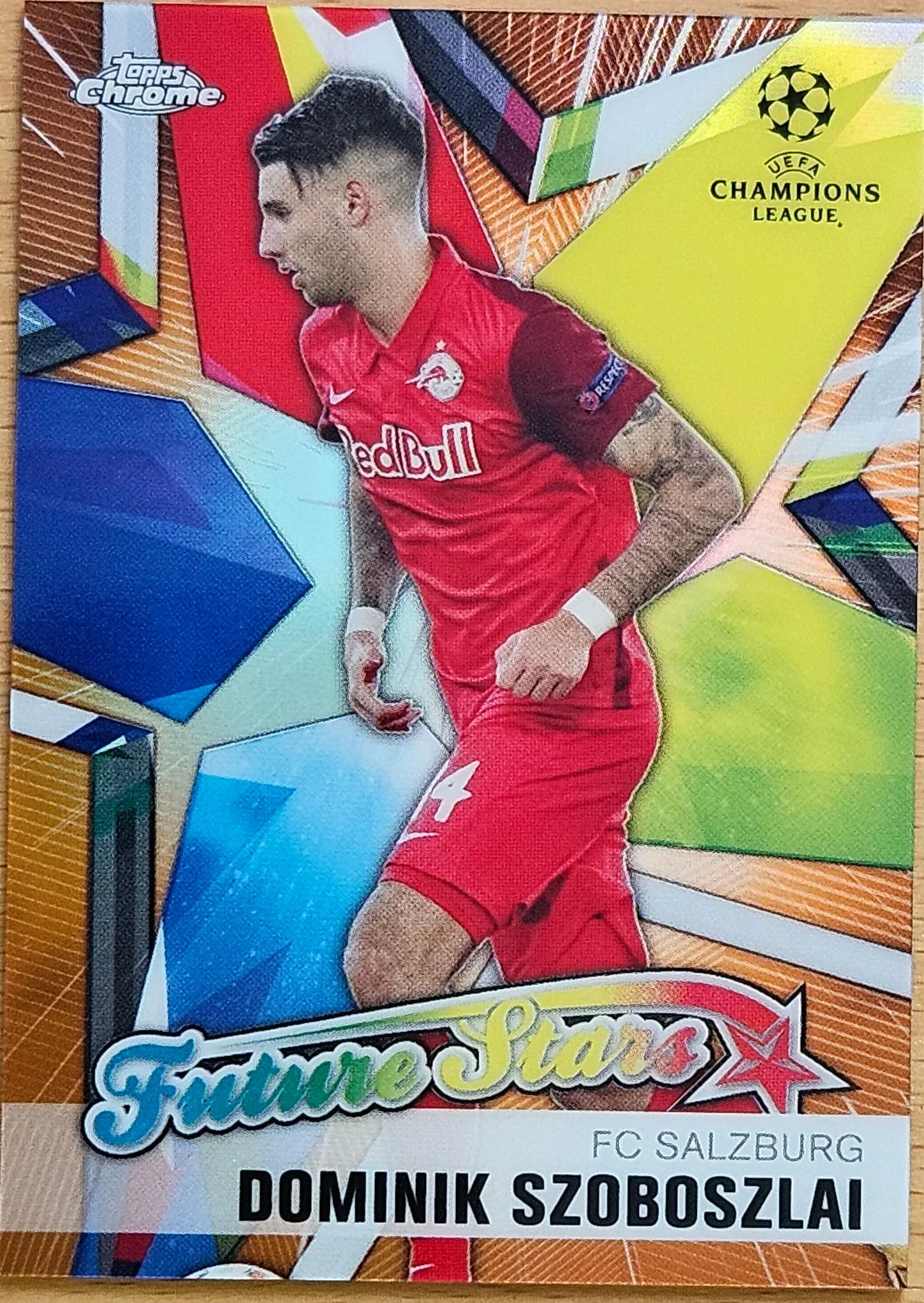 front of Dominik Szoboszlai's Topps Chrome UEFA Champions League card at high resolution